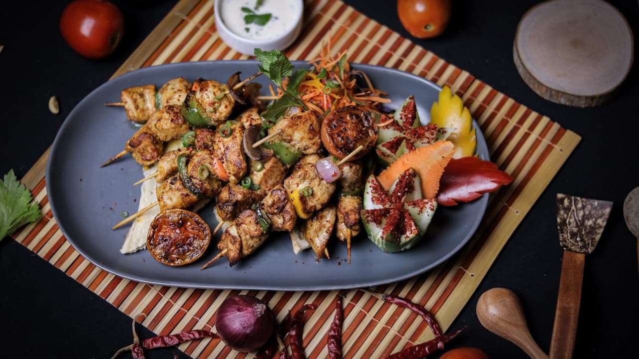 Colorful healthy dinner plates with grilled chicken, vegetables, and quinoa