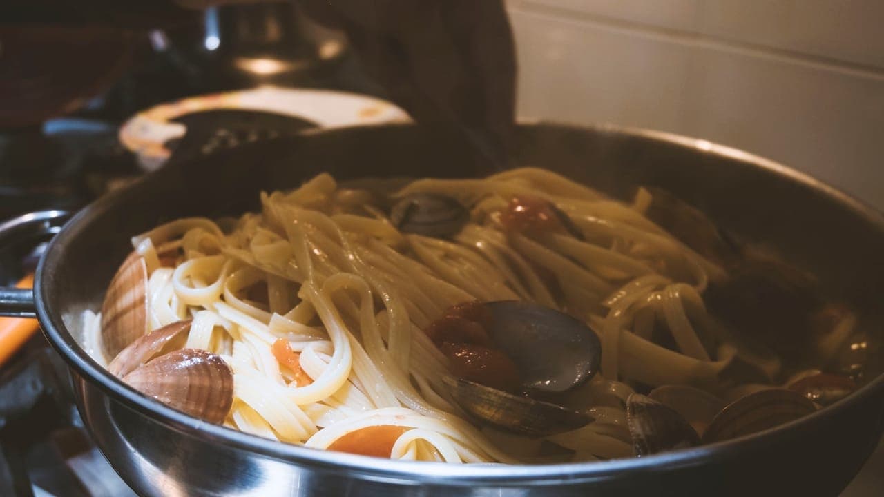 Creamy one-pot pasta with chicken and spinach in a Dutch oven