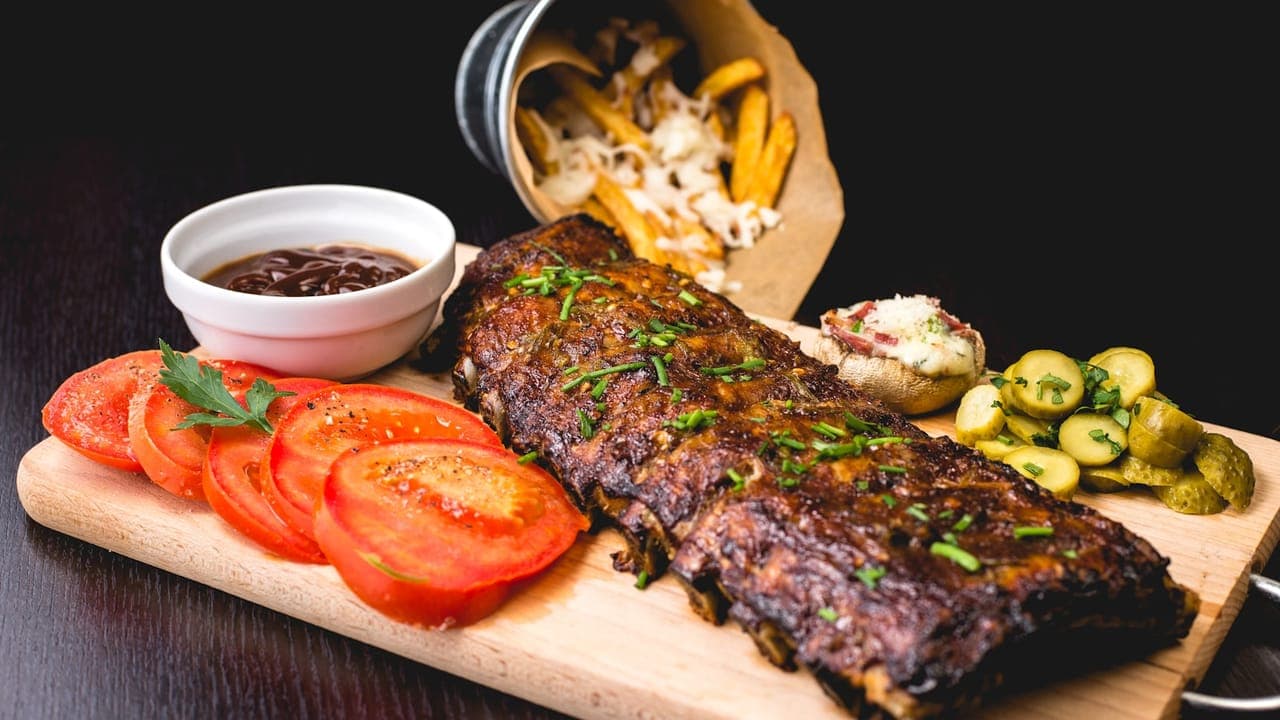 Meal prep containers filled with rice, grilled chicken, and roasted vegetables arranged on a kitchen counter