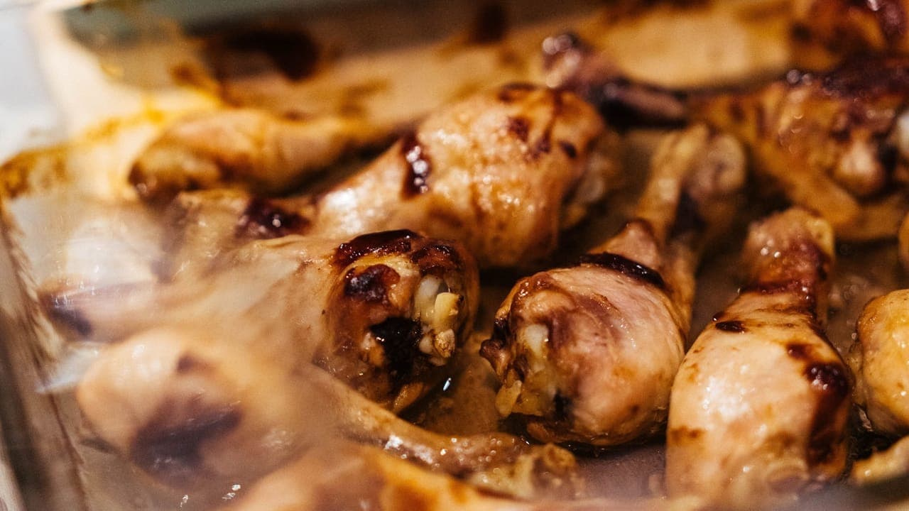 Golden crispy baked chicken drumsticks on a baking sheet seasoned with smoked paprika and garlic