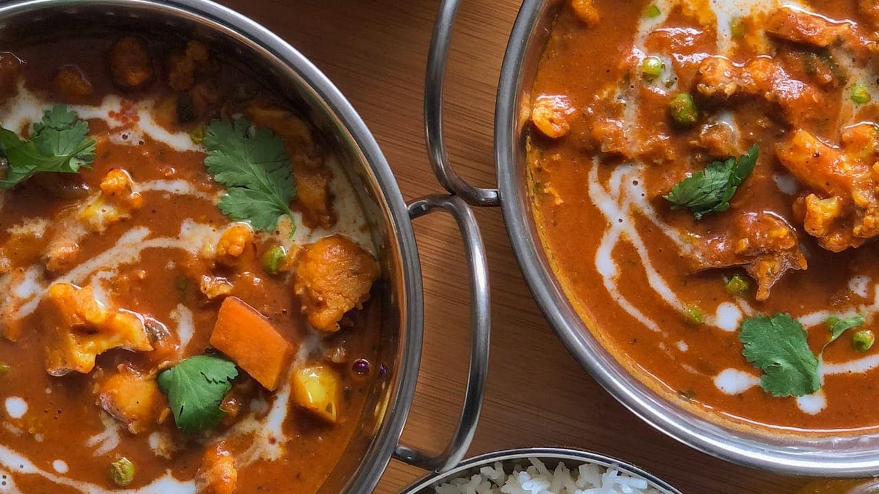 Creamy chickpea curry in a bowl served over fluffy white rice garnished with fresh cilantro
