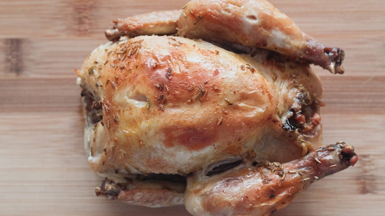 Golden crispy baked chicken thighs on a wire rack over a sheet pan