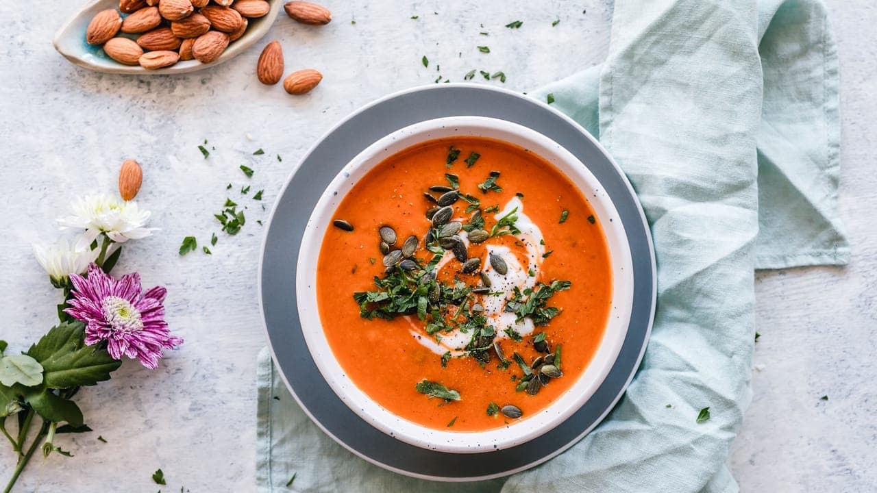 Bowl of hearty lentil soup garnished with fresh parsley and a squeeze of lemon