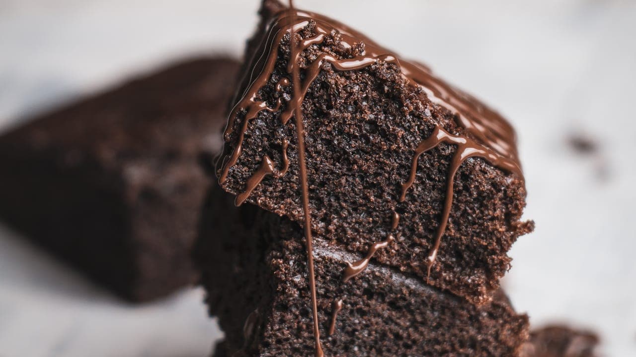 Rich chocolate mug cake in a white ceramic mug topped with a dusting of powdered sugar