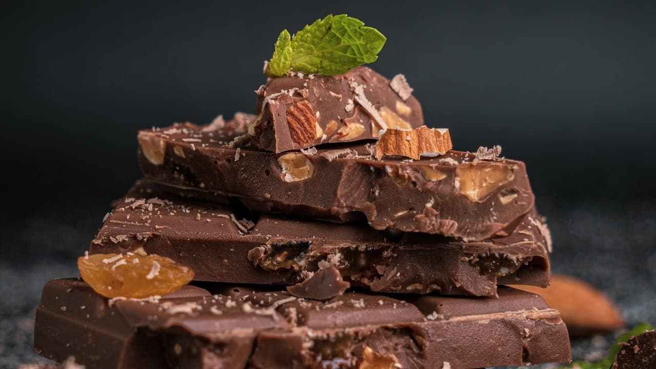 Sliced no-bake peanut butter oat bars with chocolate chips on parchment paper