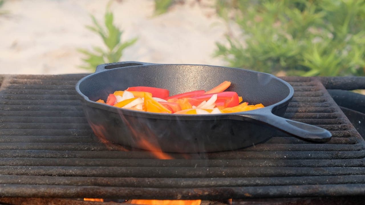 Italian sausage links with roasted bell peppers and onions on a sheet pan