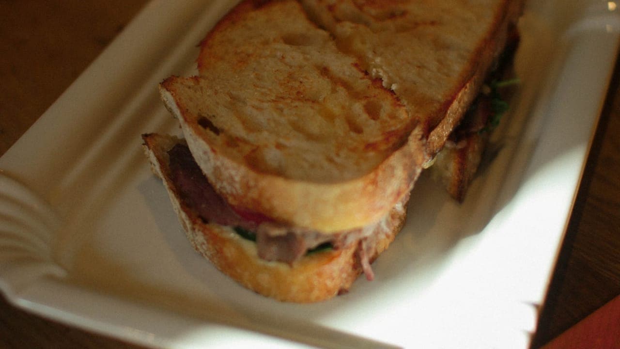 Slow cooker pulled pork shredded with two forks showing tender, juicy meat with a smoky seasoning
