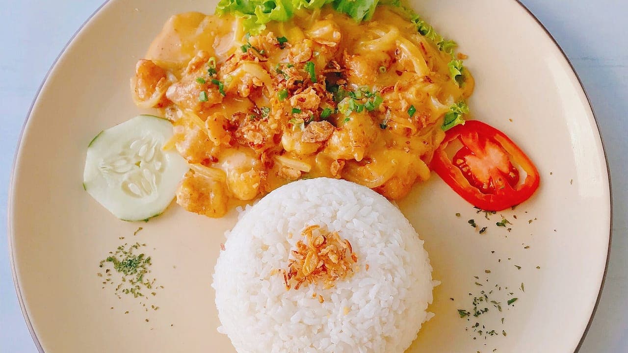 Bowl of hearty taco soup topped with shredded cheese, sour cream, and crushed tortilla chips