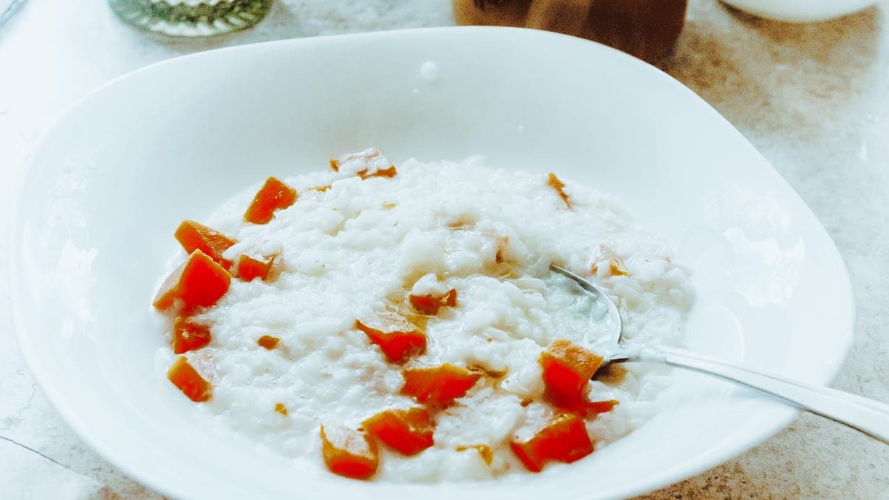 Bowl of creamy white chicken chili topped with sour cream, cilantro, and lime wedge